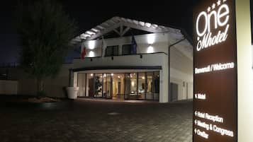 Welcome to One Hotel, a modern building with a flat roof and glass facade.