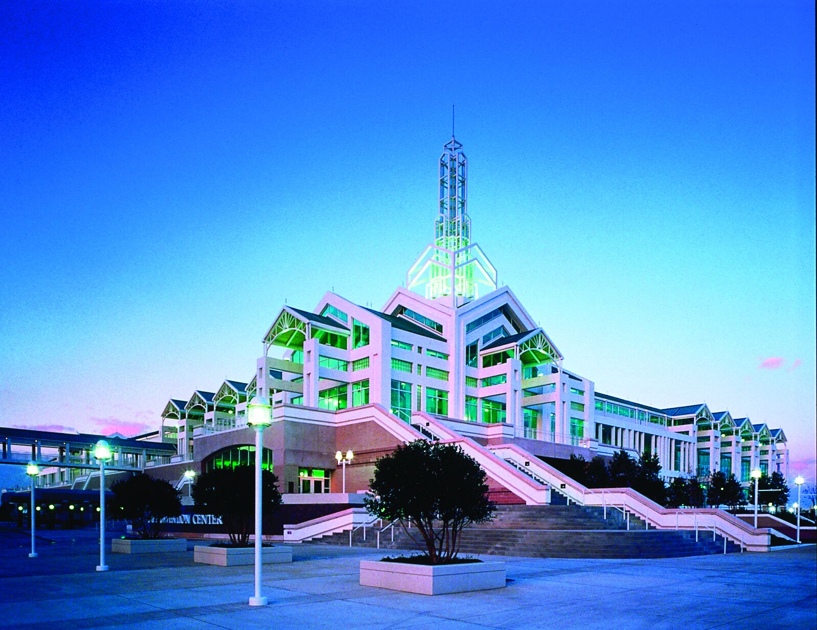 A modern building with multiple floors and a prominent tower.