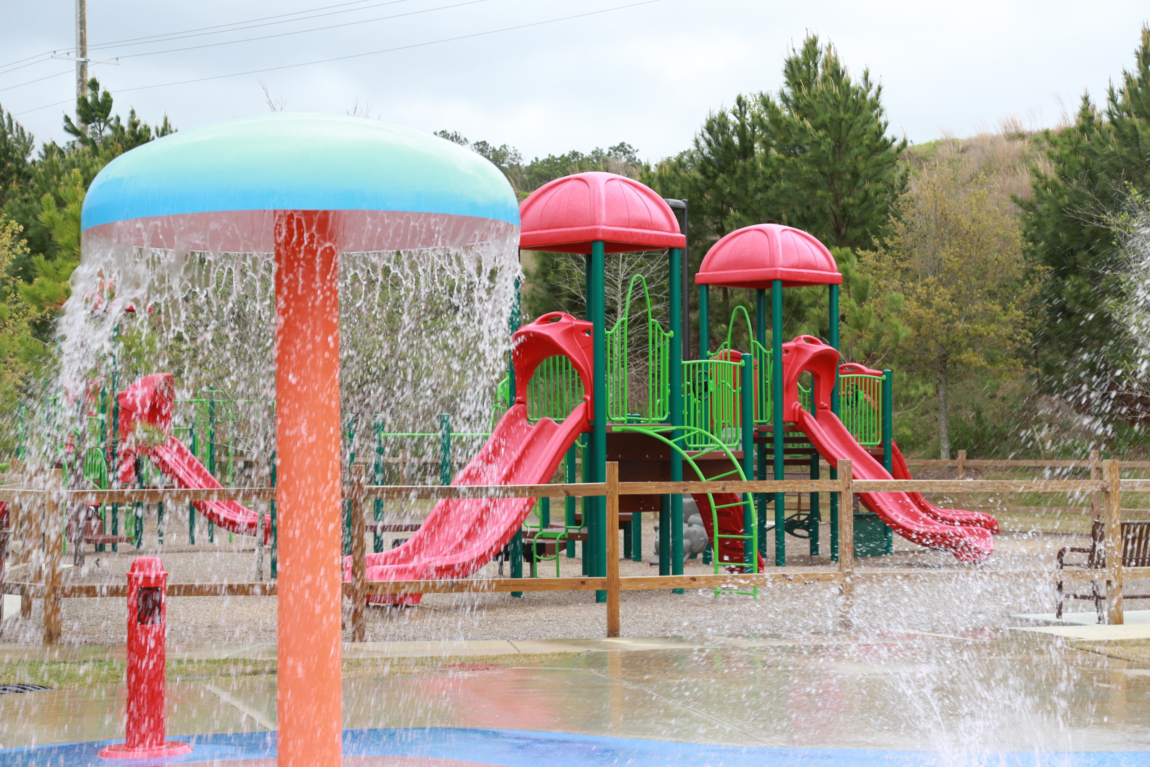 A water play area with multiple slides and a water fountain.