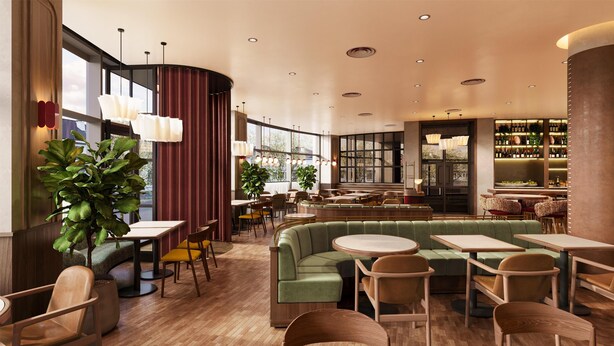 A modern restaurant with wooden flooring, green seating, and a bar area with shelves of bottles. - Radisson RED London Twickenham (Twickenham)