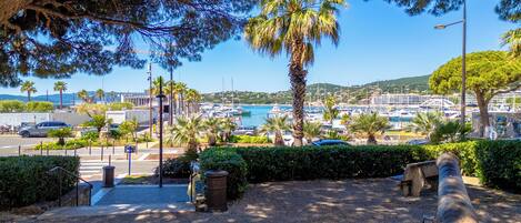 A marina with boats, a clear sky, and a view of the town in the background.