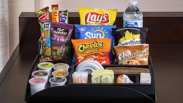 A tray with various snacks and beverages, including Lay's, Cheetos, and Smartfood.