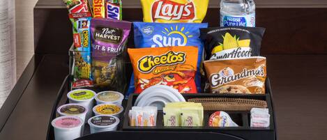 A tray with various snacks and beverages, including Lay's, Cheetos, and Smartfood.
