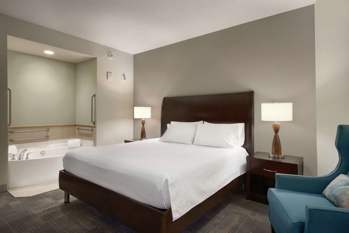 Room, 1 King Bed, Whirlpool, Accessible Roll-in Shower | Bathroom | Combined shower/tub, free toiletries, hair dryer, towels