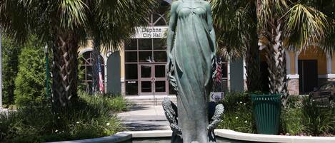 A statue in a fountain with a building labeled "Daphne City Hall" in the background.