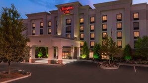 A Hampton Inn hotel with a modern facade, multiple floors, and a well-lit entrance. - Hampton Inn Springfield South Enfield (Enfield)