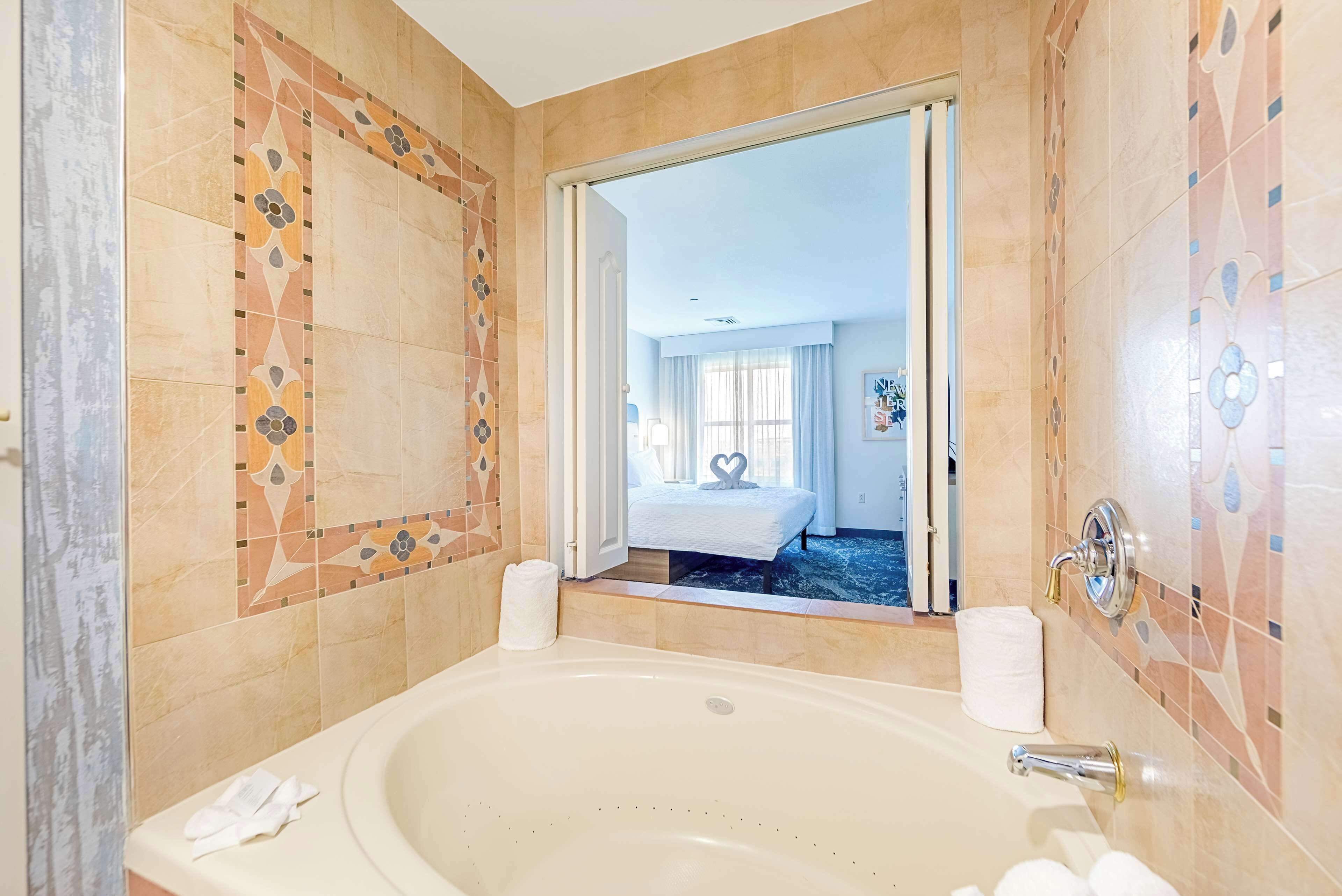 suite, 1 king bed, accessible (hearing) | bathroom | free toiletries, hair dryer, towels