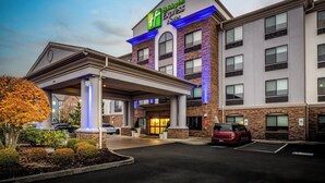 A Holiday Inn Express building with a covered entrance, brick facade, and multiple windows. - Holiday Inn Express Hotel & Suites Vancouver Mall by IHG (Vancouver)