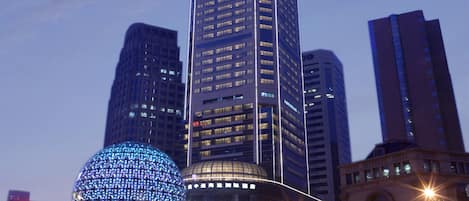 A high-rise building with 'INTERCONTINENTAL' signage, surrounded by other tall buildings and a spherical light installation.