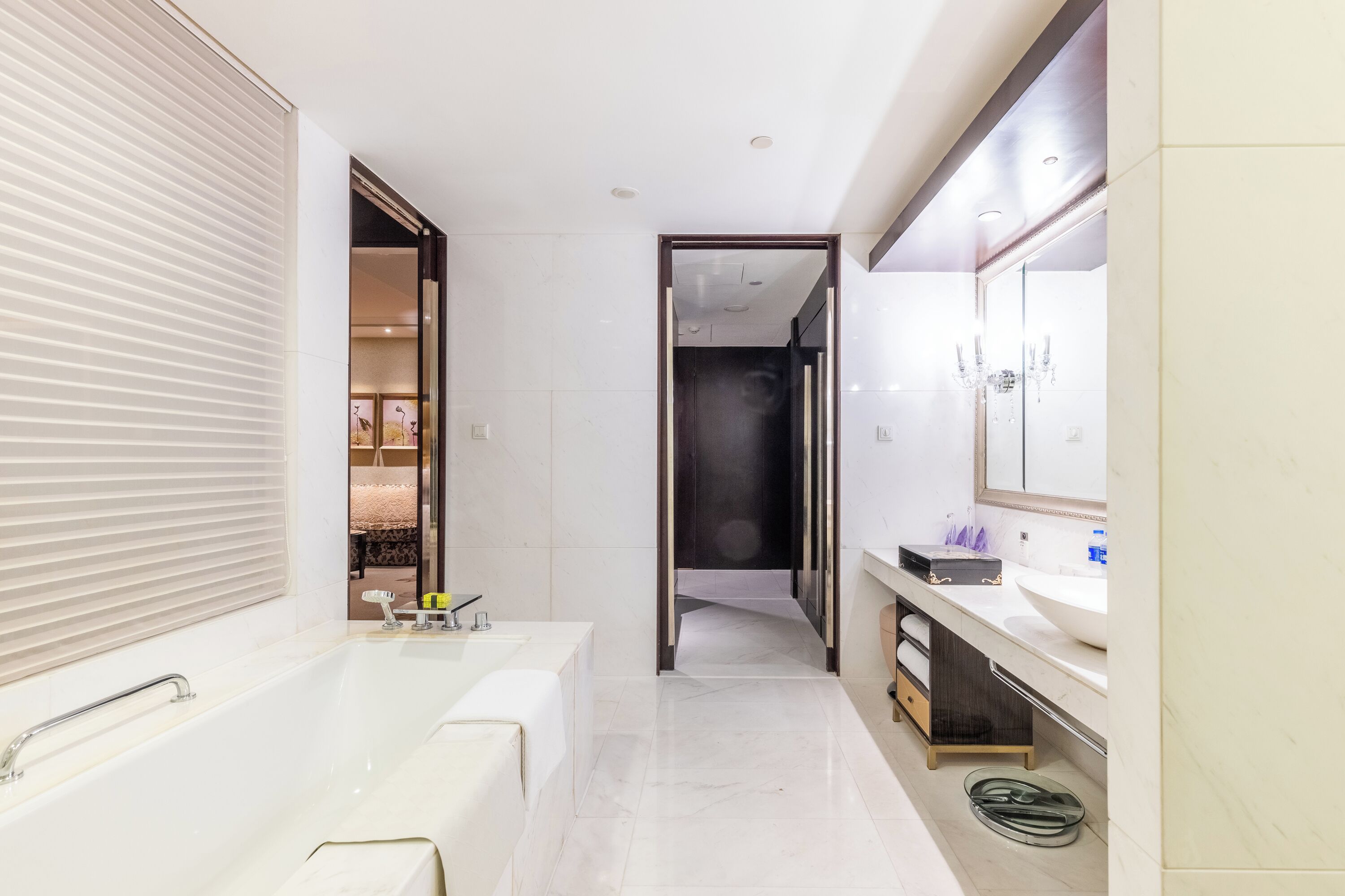 A modern bathroom with a large bathtub, a vanity with a mirror, and a walk-in shower.