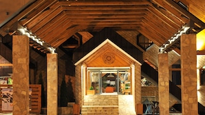 A hotel entrance with a stone facade, wooden beams, and a sign indicating it is a hotel. - Bianca Resort & Spa (Kolašin)
