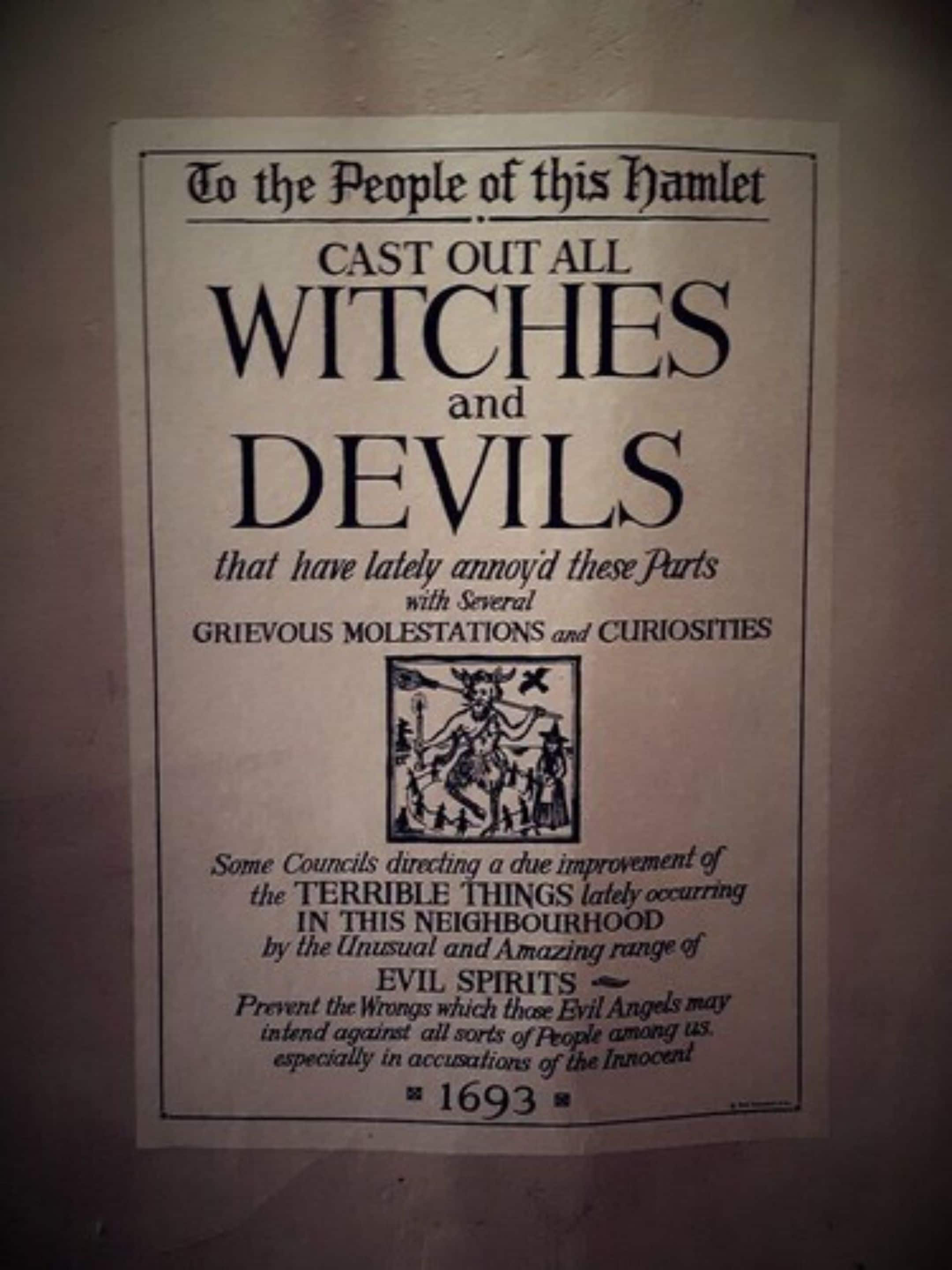 A historical document titled 'To the People of this Hamlet' from 1693, addressing the issue of witches and devils in the neighborhood.