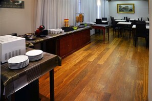 Enjoy meals in this well-appointed dining area with a long table and buffet counter.
