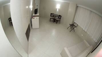A compact living space with a kitchenette, a dining area, and a seating area.