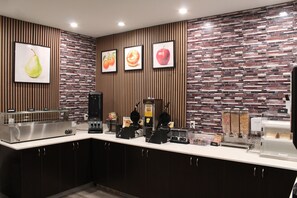 A modern kitchen with a white countertop, stainless steel appliances, and a brick-patterned backsplash. -  La Quinta Inn and Suites by Wyndham Schertz-San Antonio-Selma (Schertz)
