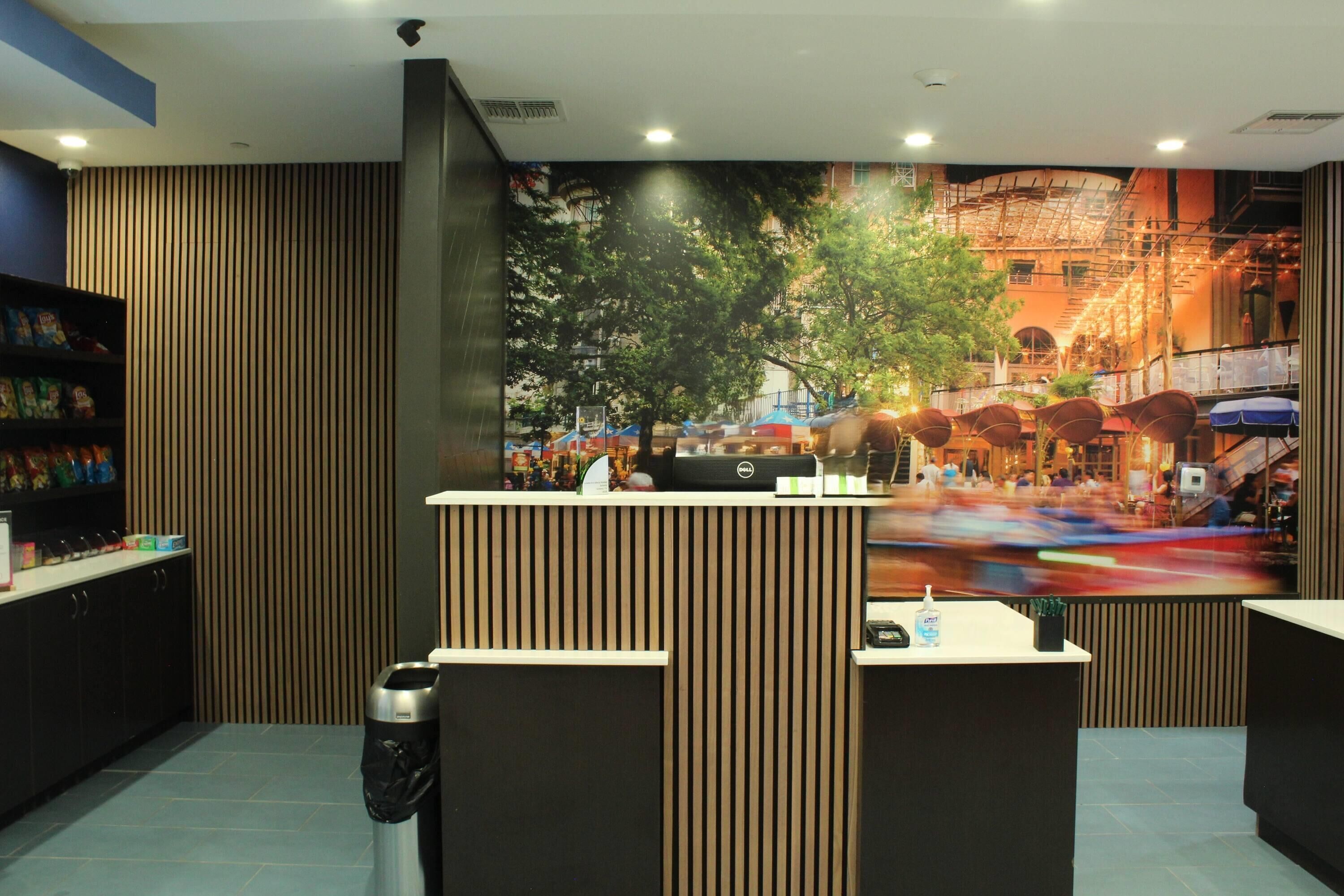 A reception desk with a view of a busy street through a large window.