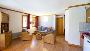 A cozy living room with wooden furniture, a sofa, and a coffee table.