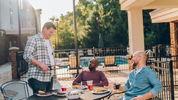 Enjoy a casual meal in our outdoor dining area with a round table and comfortable seating.