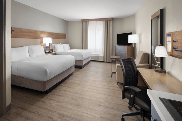 A hotel room with two beds, a desk, a chair, a TV, and a window with curtains. - Candlewood Suites Aberdeen-Bel Air by IHG (Bel Air)