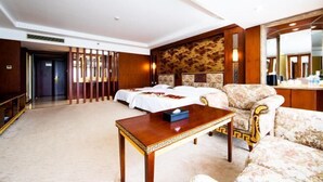 A hotel room with two beds, a wooden coffee table, a sofa, and a large mirror. - Beijing Bao Lin Xuan International Hotel (Beijing)