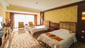 A hotel room with two beds, a desk with a chair, a television, and a large window. - Beijing Bao Lin Xuan International Hotel (Beijing)
