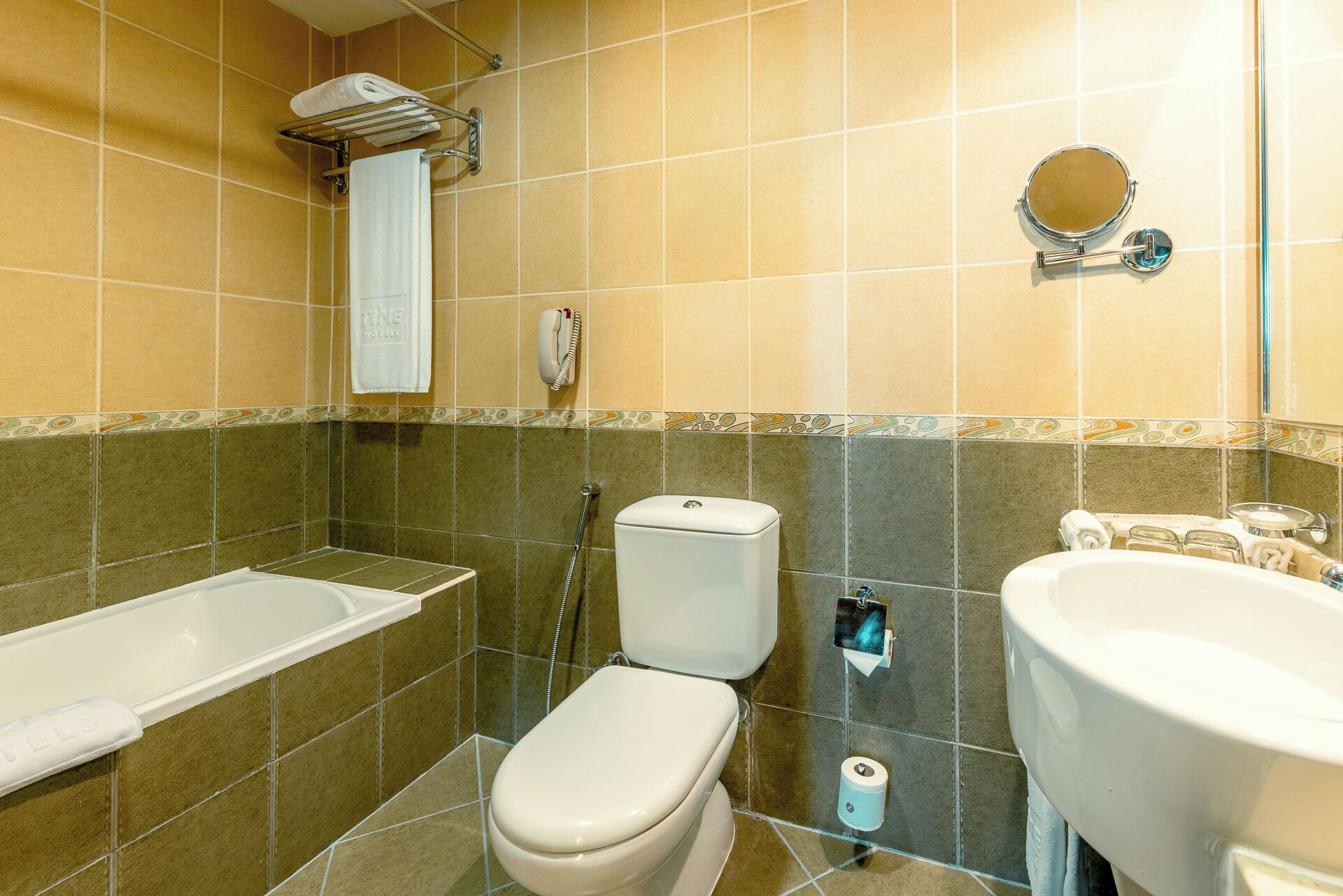 A bathroom with a bathtub, toilet, and sink.