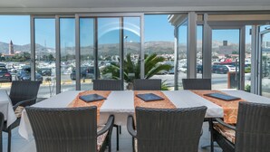 A restaurant with a terrace overlooking a marina and cityscape. - Hotel Trogir Palace (Trogir)