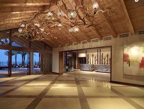 Experience a unique blend of modern and natural elements in this inviting space, featuring a stunning chandelier and geometric tile design.