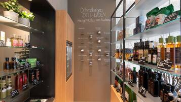 A modern retail space with glass shelves displaying various products.