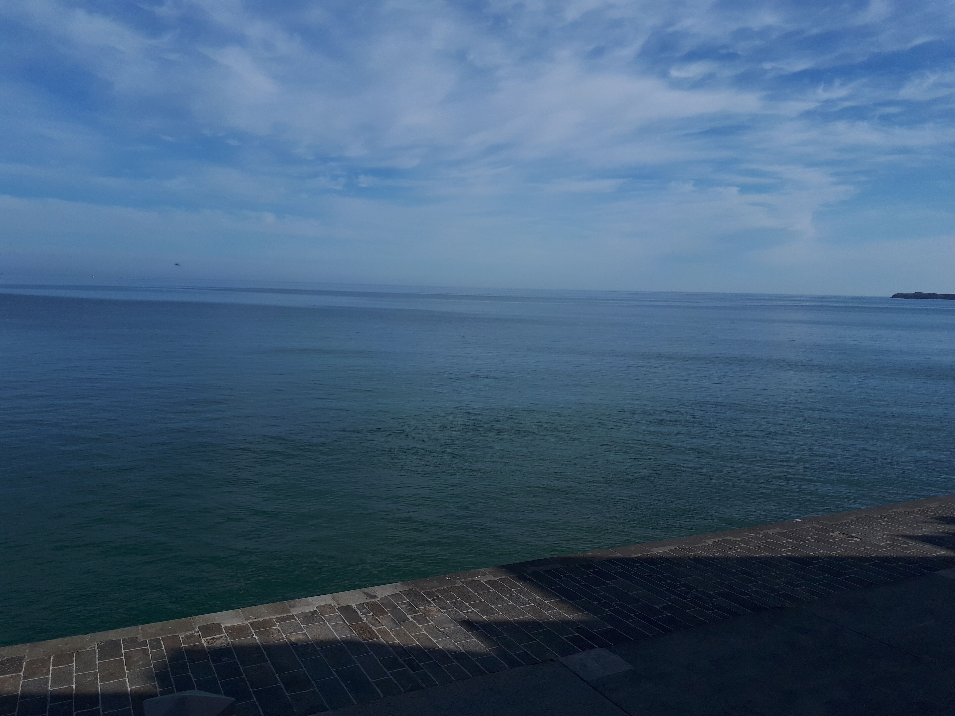 A waterfront view with a paved walkway along the edge.