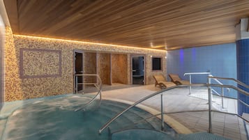 Relax by the pool surrounded by a mosaic tile pattern and comfortable lounge chairs.