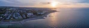 Stroll along the waterfront and discover a charming coastal town with a well-organized residential area and a historic building.