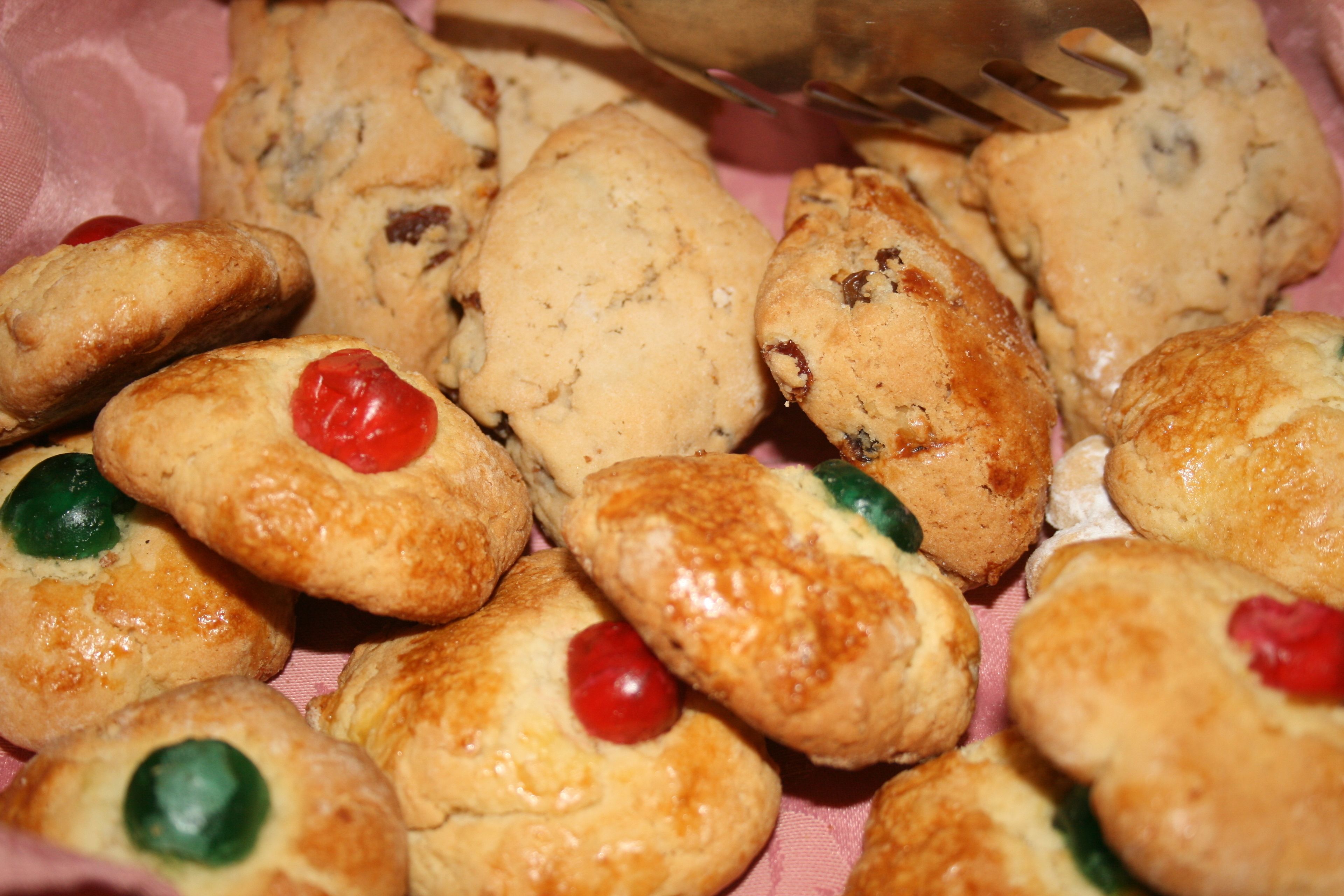 A variety of baked goods, including cookies and pastries, some with visible fruit toppings.