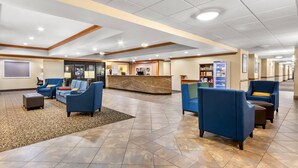 A spacious lobby with blue seating, a reception desk, and a coffee station. - Comfort Inn & Suites Thatcher - Safford (Thatcher)