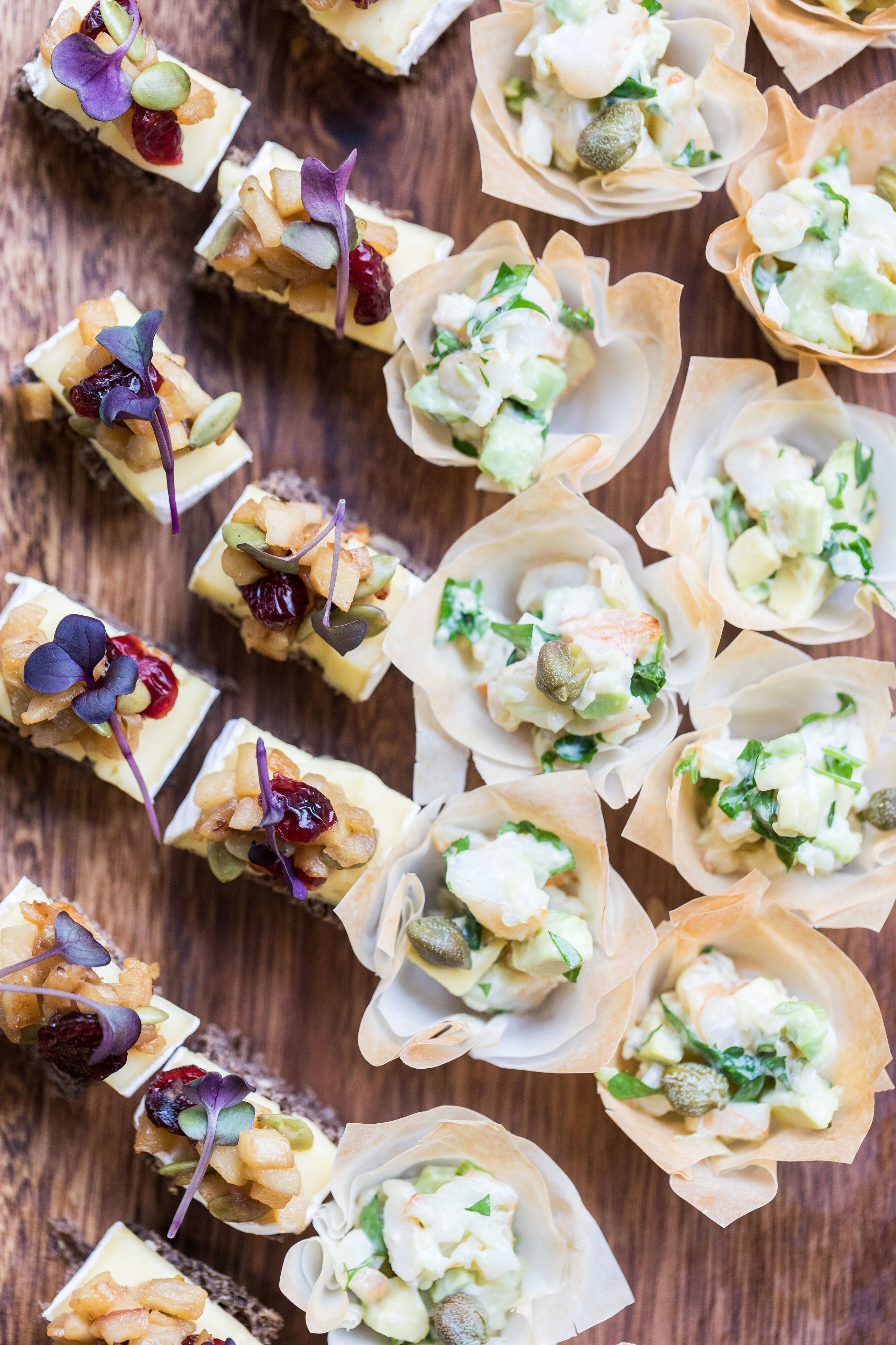 A variety of appetizers arranged on a wooden surface.