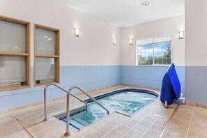 Relax by the serene indoor pool, surrounded by comfortable seating and natural light.