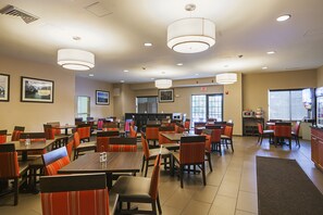Enjoy meals in a spacious dining area with comfortable seating and ample lighting.