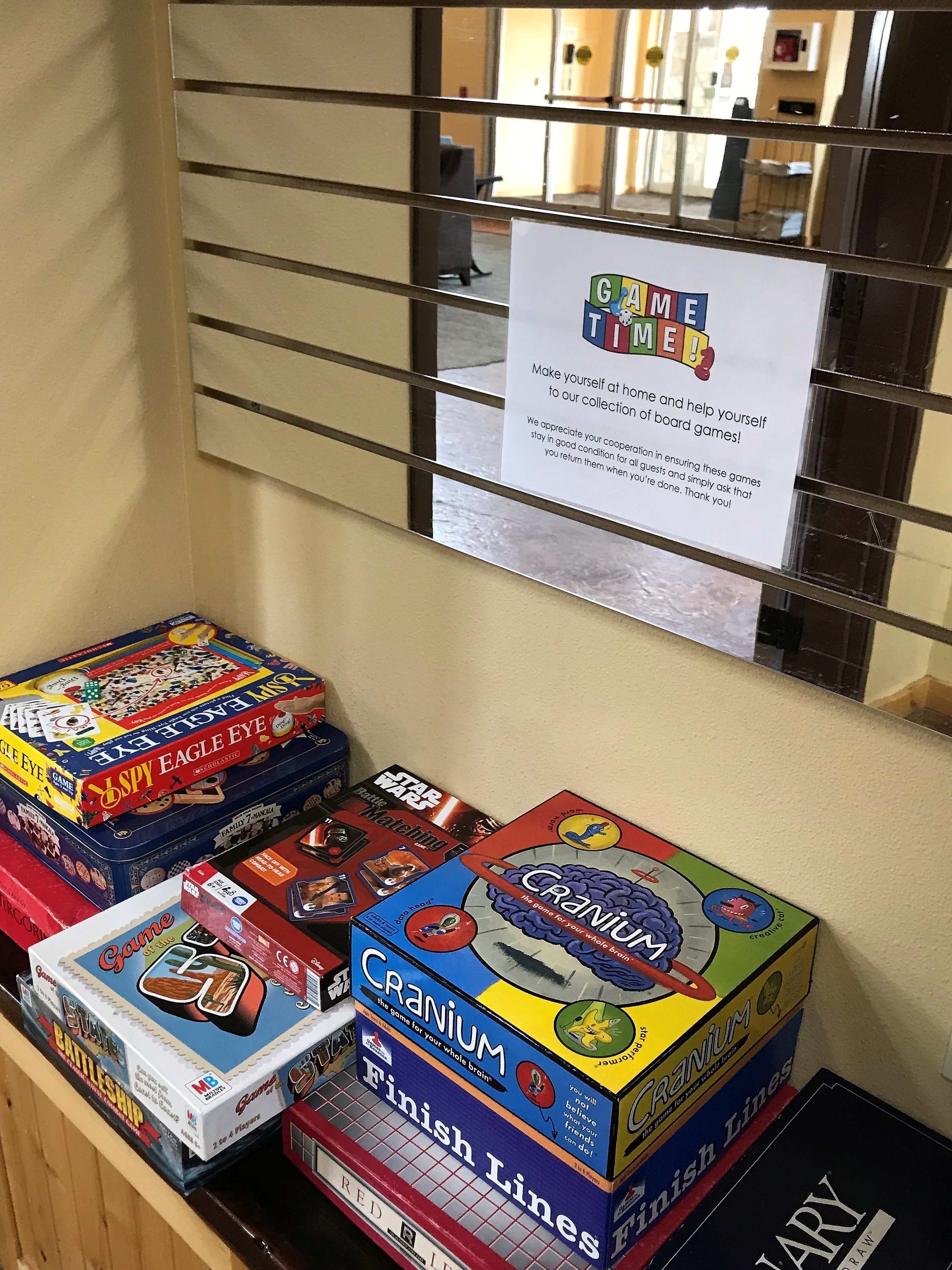 A display of board games with a sign above them.