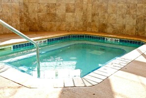 Enjoy a refreshing swim in the rectangular pool surrounded by tiled walls.