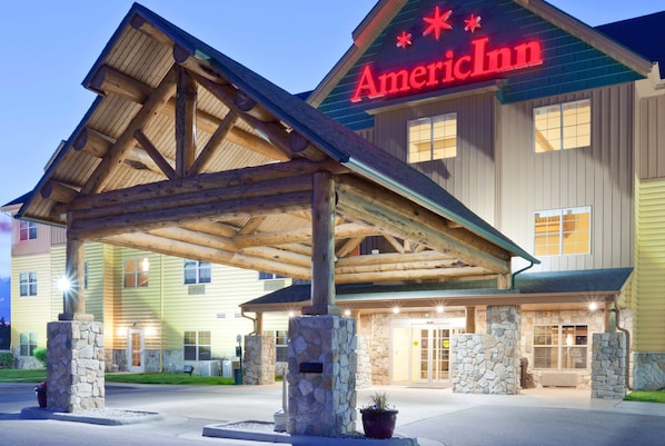 Traditional American Inn with a charming entrance, featuring a stone fireplace and glass doors.