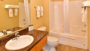 A bathroom with a sink, toilet, and bathtub.