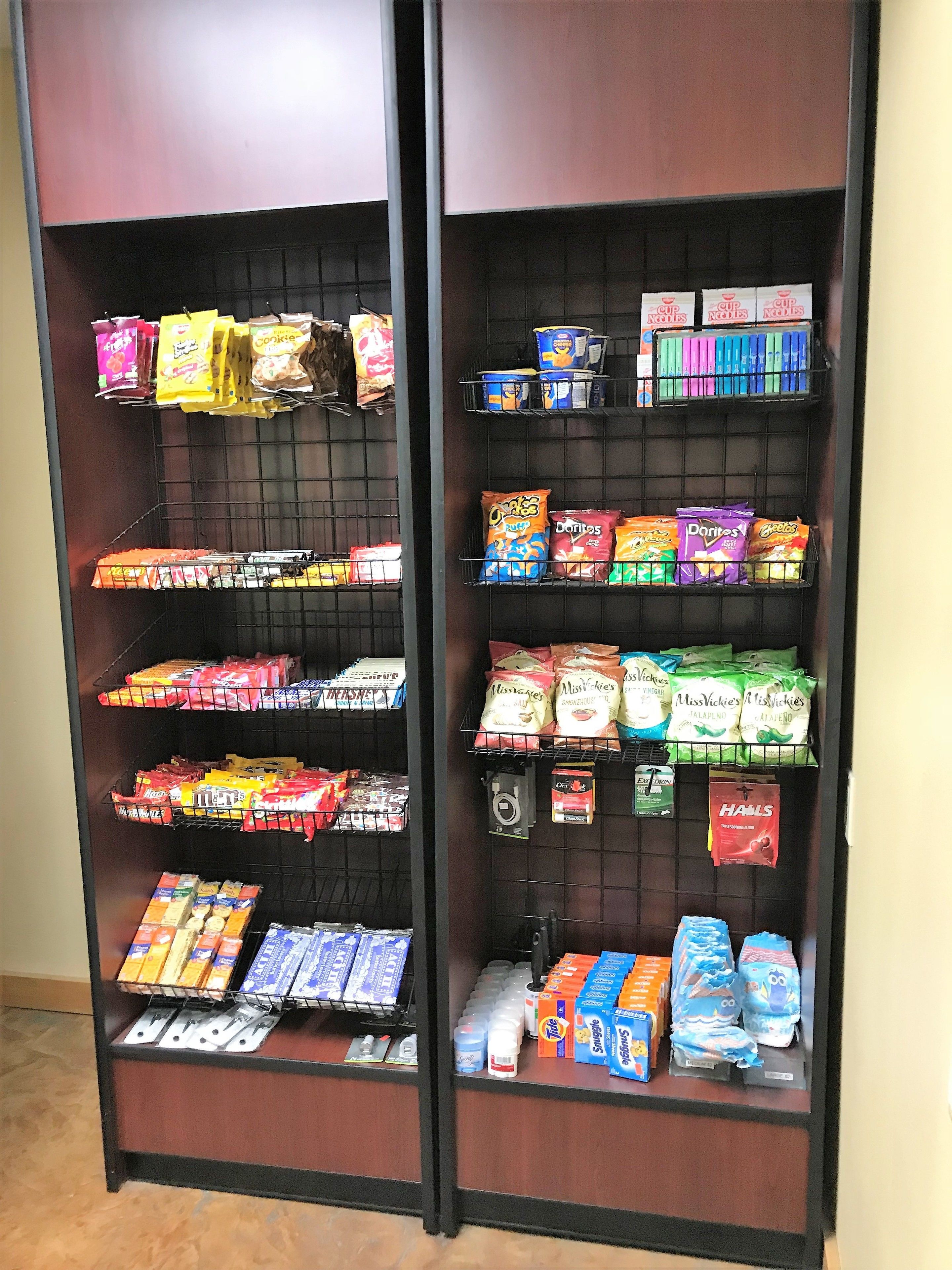 A snack display with various packaged foods and beverages.