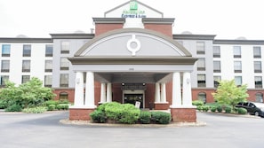 A Holiday Inn Express & Suites building with a brick facade, white columns, and a large entrance. - Holiday Inn Express Hotel & Suites Kodak East - Sevierville by IHG (Kodak)