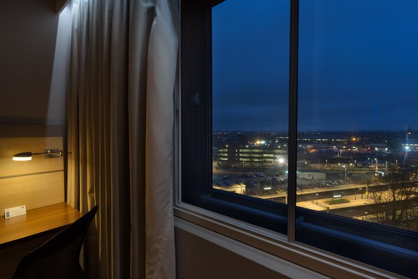 A hotel room with a large window overlooking a cityscape at night. - Holiday Inn Express London-Watford Junction by IHG (Watford)