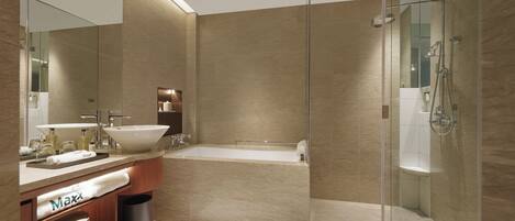A modern bathroom with a large sink, bathtub, and glass-enclosed shower.