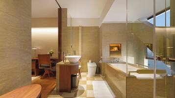 A modern bathroom with a large bathtub, a sink, and a mirror.