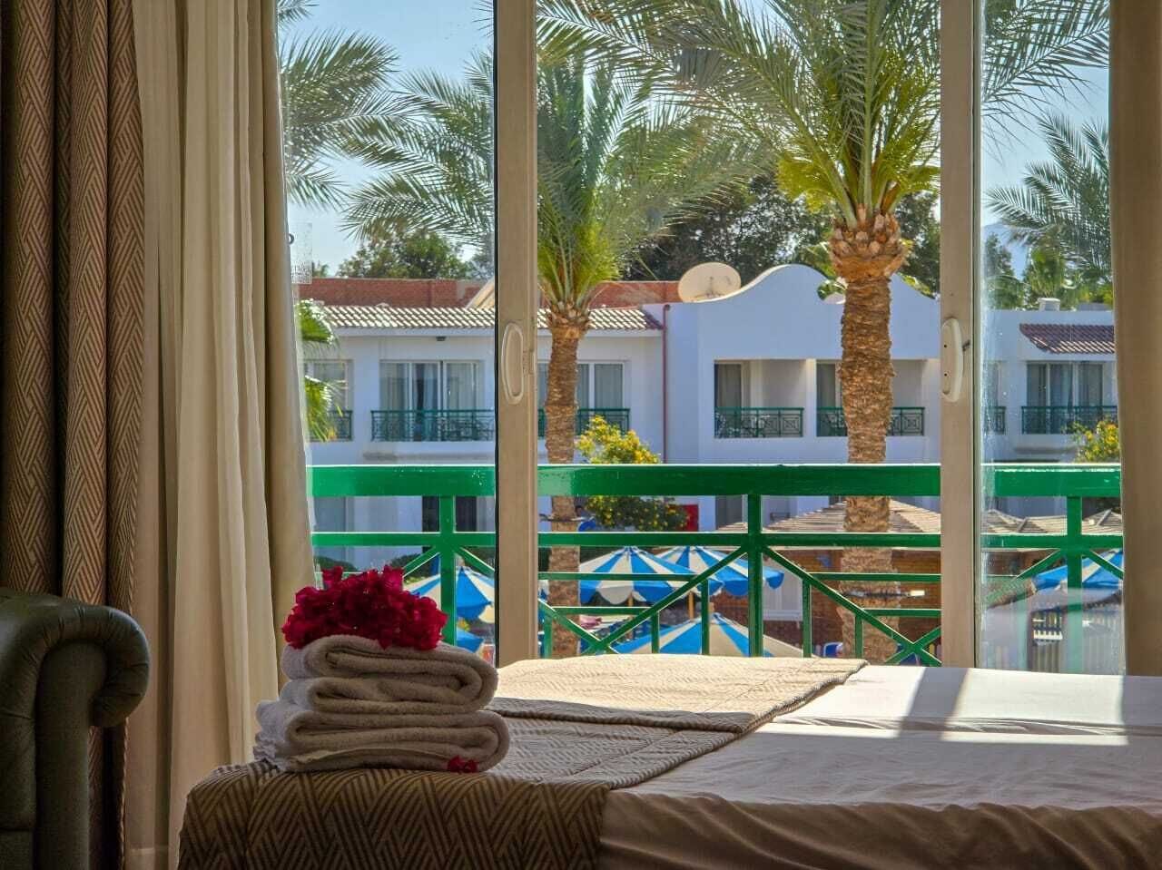 Deluxe Double or Twin Room, Pool View | Free minibar items, in-room safe, blackout curtains, iron/ironing board