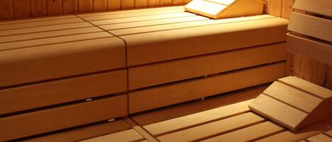 A wooden sauna with benches and a bench seat.