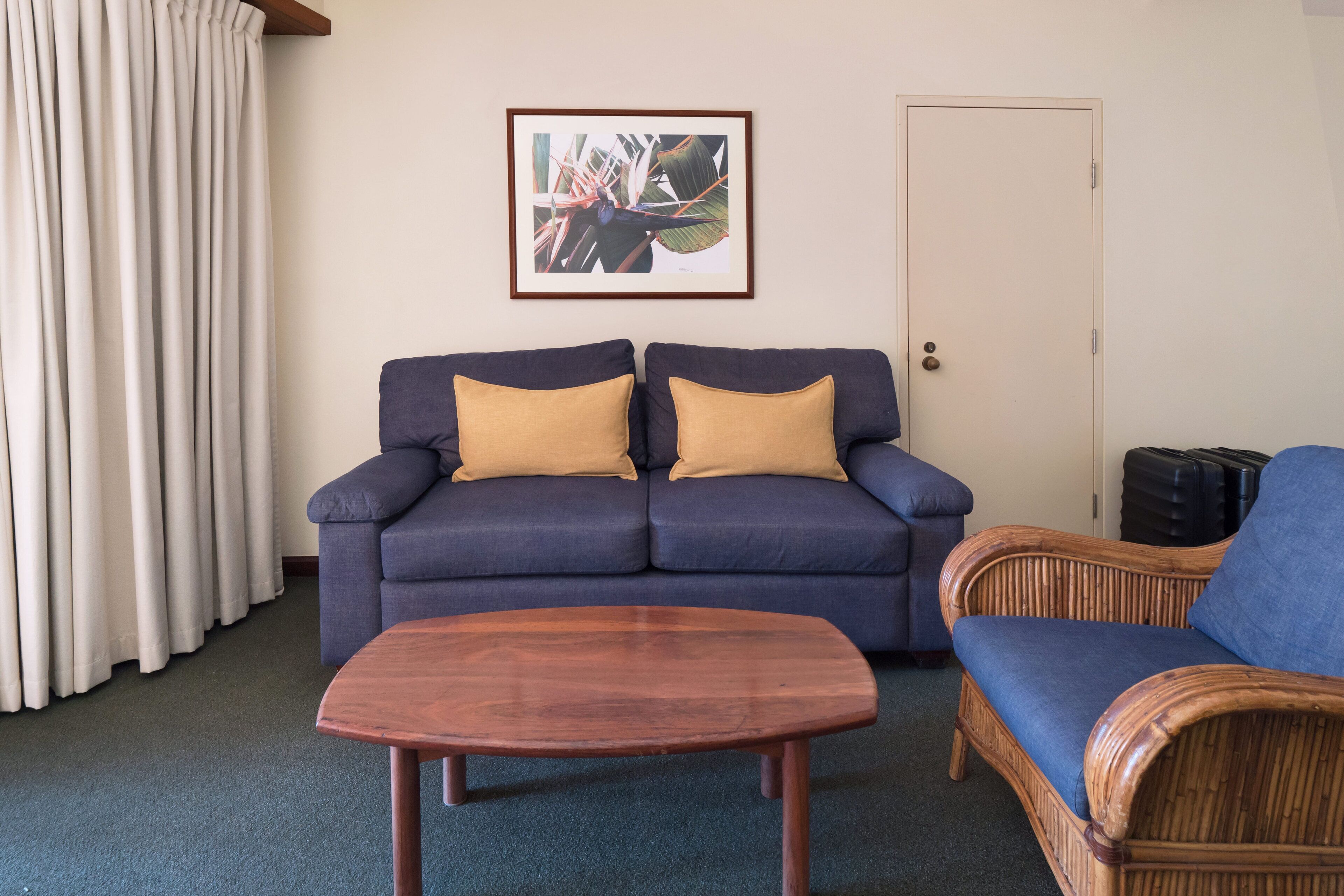 classic beach balcony suite | living area | smart tv, books, streaming services