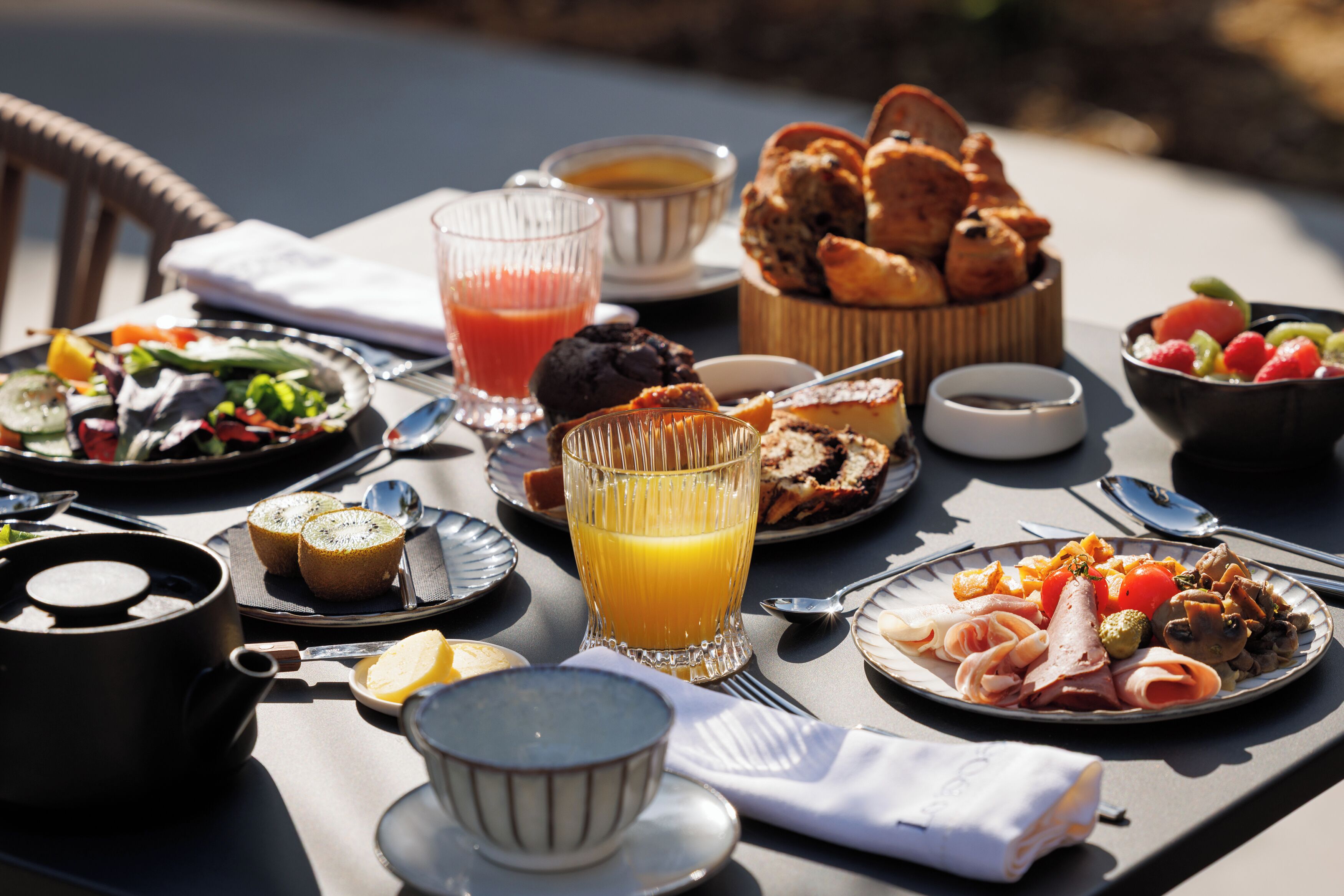 A table set with breakfast items including toast, eggs, and a fruit salad.